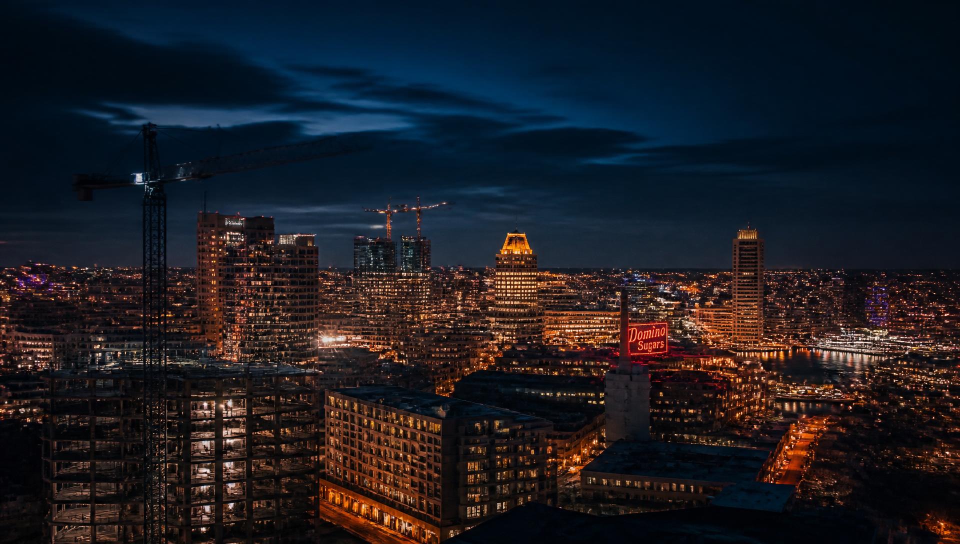Baltimore skyline at night with construction cranes